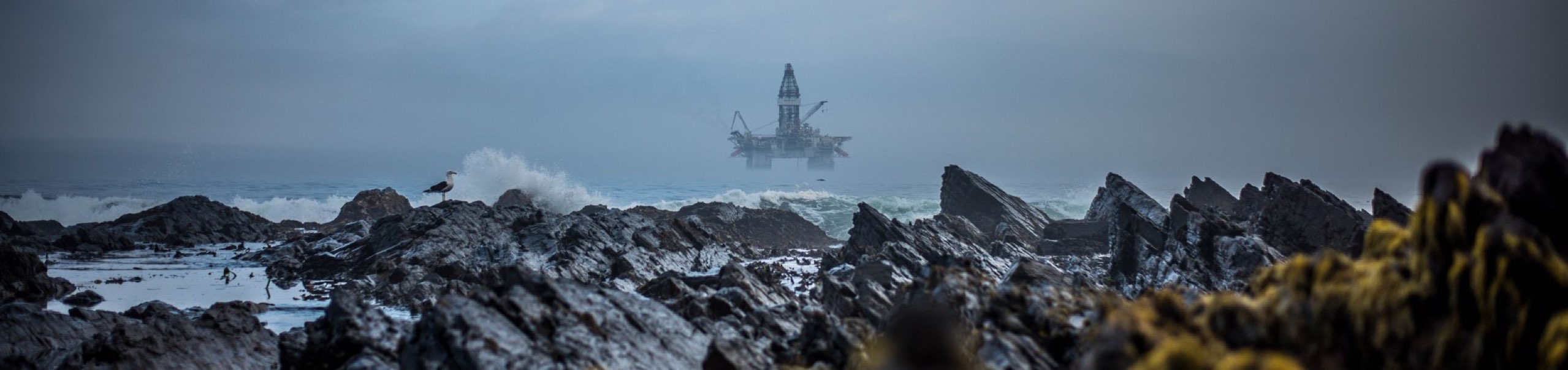 Rocky beach with an Oilrig in the view